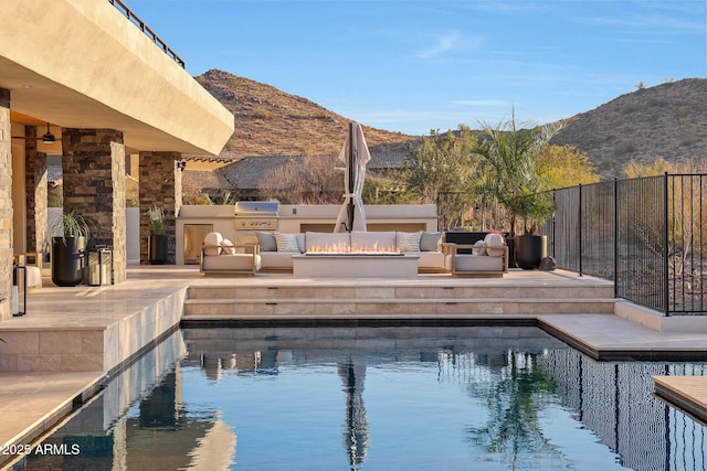 view of swimming pool with area for grilling, a mountain view, outdoor lounge area, and a patio