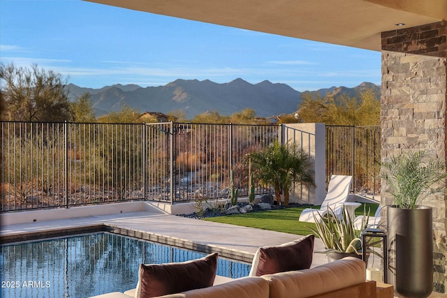 view of swimming pool featuring a patio and a mountain view