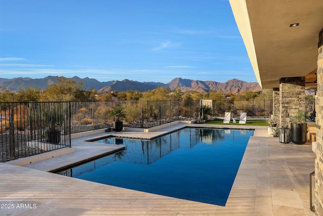 view of swimming pool featuring a mountain view and a patio