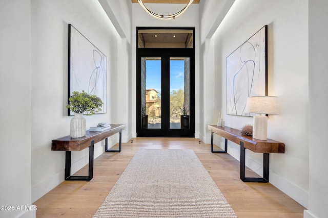 entryway featuring light wood-type flooring and french doors