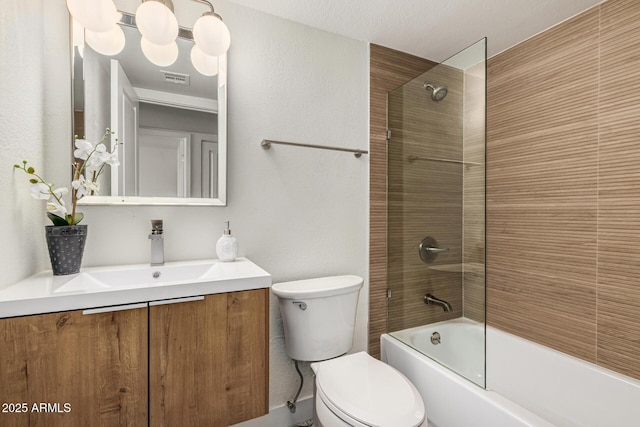 full bathroom with toilet, vanity, and tiled shower / bath combo