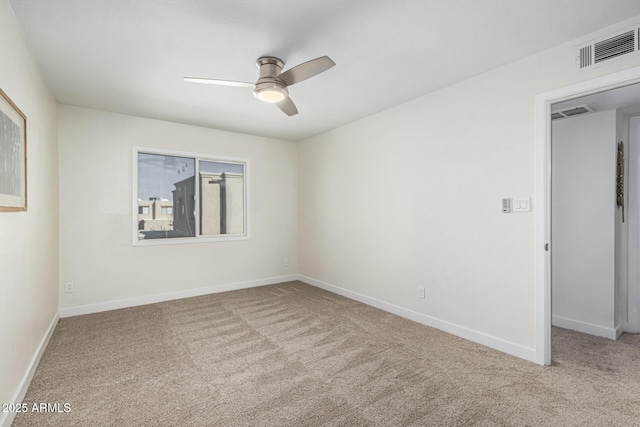 carpeted empty room featuring ceiling fan