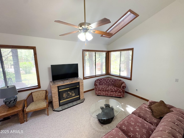 17410 S Peyote Dr, Munds Park, AZ 86017 - carpeted living room featuring a glass covered fireplace, vaulted ceiling, baseboards, and a ceiling fan