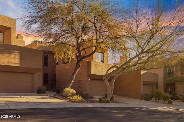 pueblo-style house with a garage