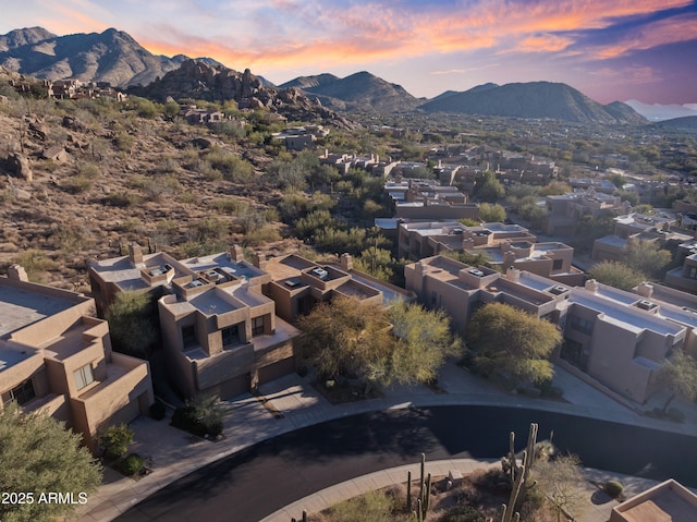 aerial view at dusk featuring a mountain view