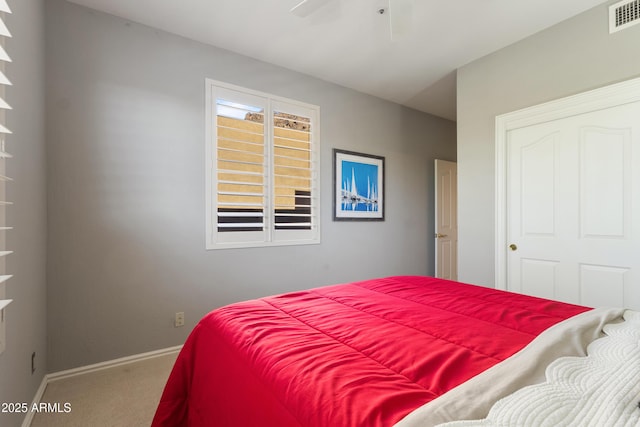 carpeted bedroom with a closet and ceiling fan