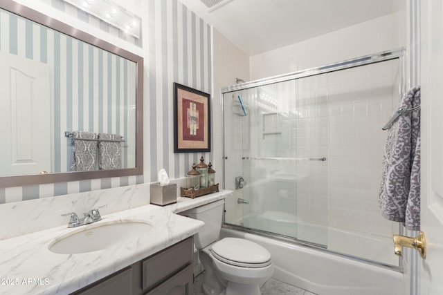 full bathroom featuring vanity, enclosed tub / shower combo, and toilet