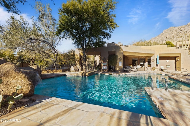 view of pool featuring a patio, a mountain view, and pool water feature