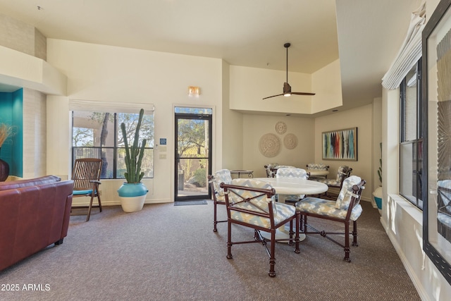 carpeted dining space featuring ceiling fan