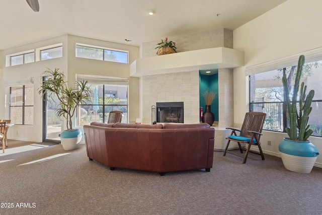 carpeted living room featuring a towering ceiling