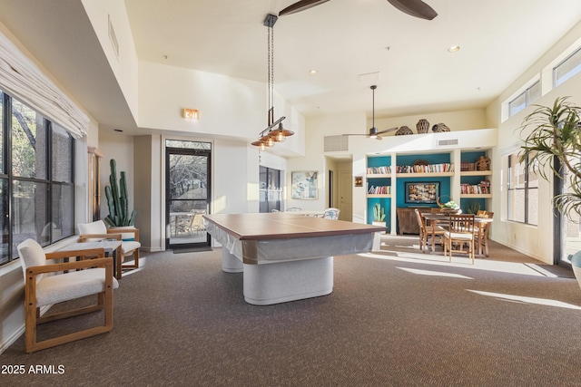 game room featuring a wealth of natural light, ceiling fan, and carpet flooring