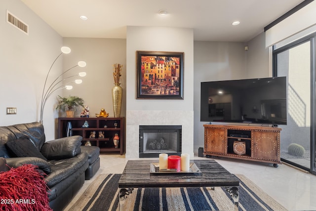 living room with a tile fireplace