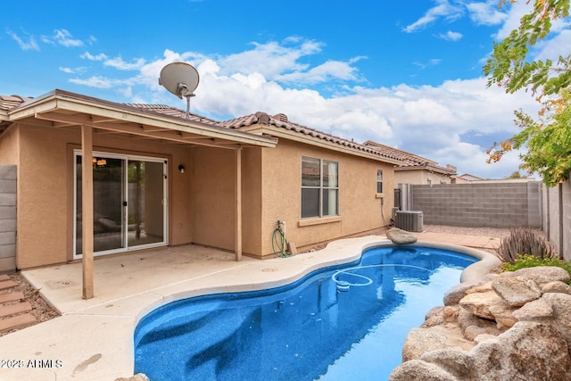 view of pool featuring a fenced in pool, a fenced backyard, central air condition unit, and a patio