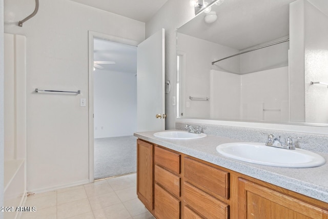 full bath featuring double vanity, a sink, ceiling fan, and tile patterned flooring