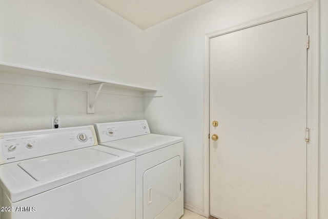 laundry area with washing machine and clothes dryer and laundry area