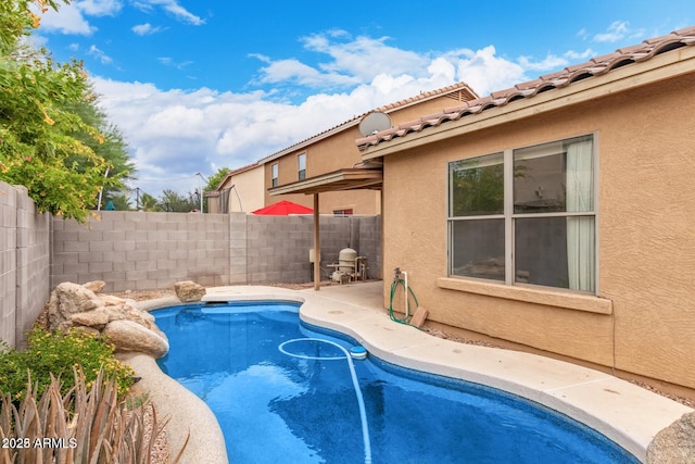 view of pool with a fenced in pool, a fenced backyard, and a patio