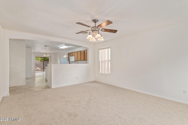empty room with light colored carpet, baseboards, and plenty of natural light