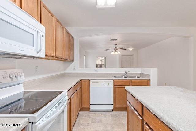 kitchen featuring ceiling fan, a sink, white appliances, light countertops, and visible vents