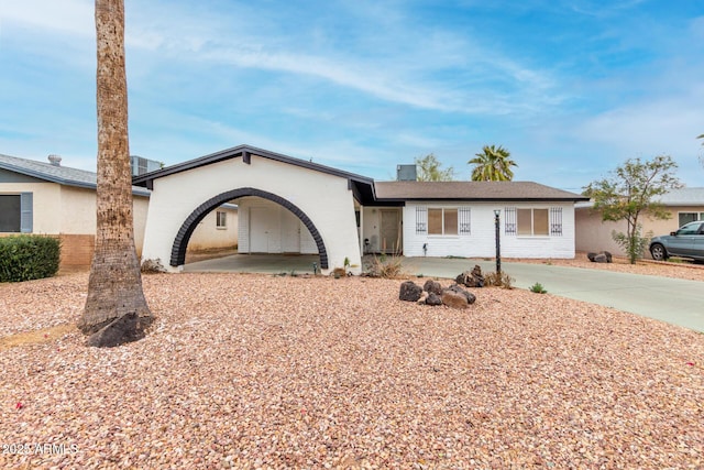 single story home featuring a carport