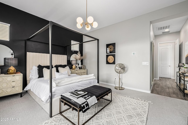 bedroom featuring carpet and a notable chandelier