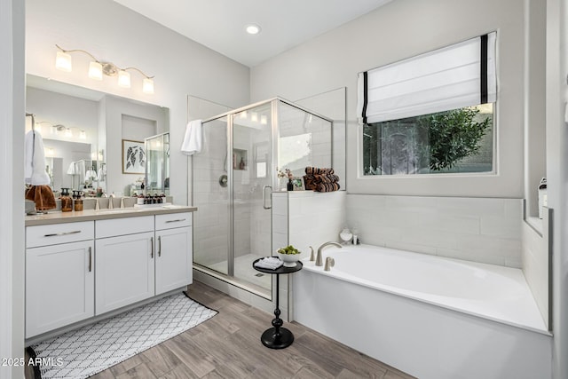 bathroom featuring vanity and independent shower and bath