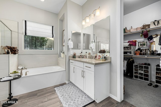 bathroom featuring separate shower and tub and vanity