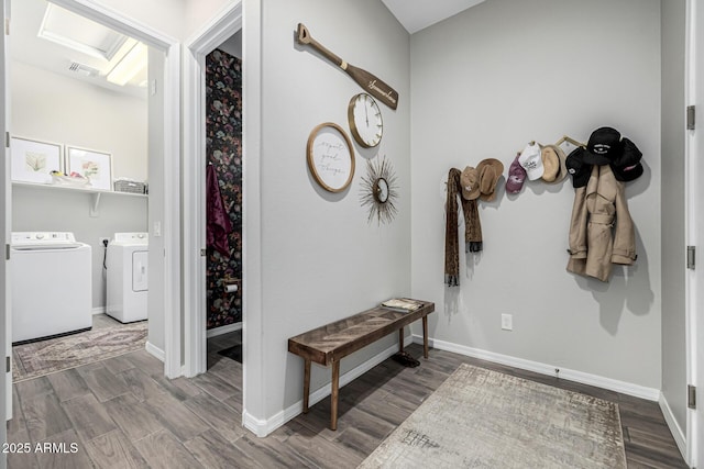 interior space with hardwood / wood-style floors and washing machine and clothes dryer