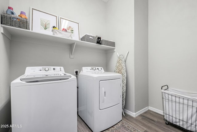 laundry room featuring wood-type flooring and washer and dryer