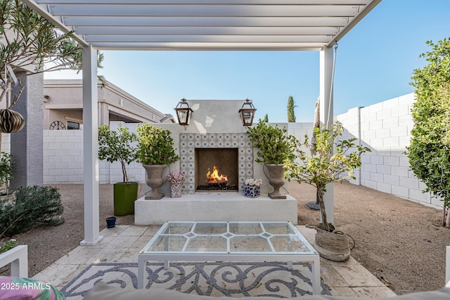 view of patio featuring an outdoor fireplace and a pergola