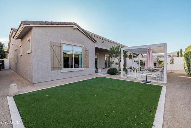 rear view of house with a patio area and a yard