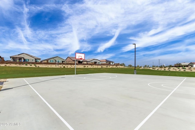 view of basketball court with a lawn