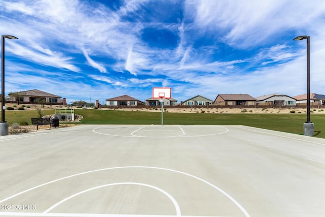 view of basketball court featuring a yard