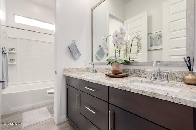 full bathroom featuring shower / tub combination, vanity, and toilet