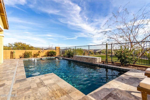 view of swimming pool featuring pool water feature and a patio area