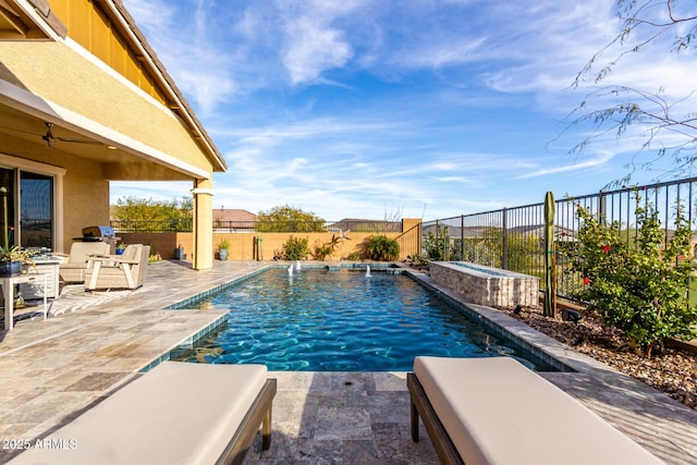 view of pool with an in ground hot tub, pool water feature, ceiling fan, and a patio