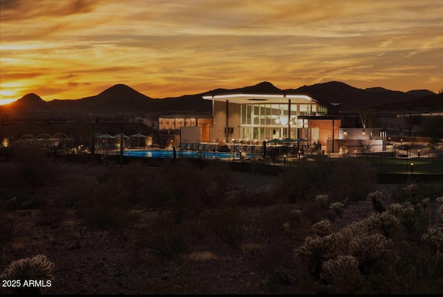 back house at dusk with a mountain view