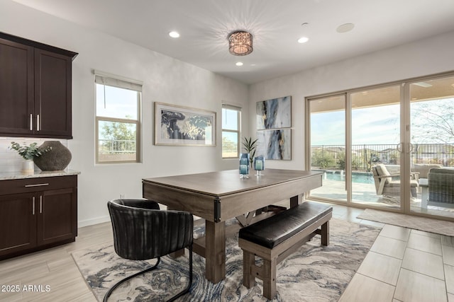 dining room with plenty of natural light and light hardwood / wood-style flooring