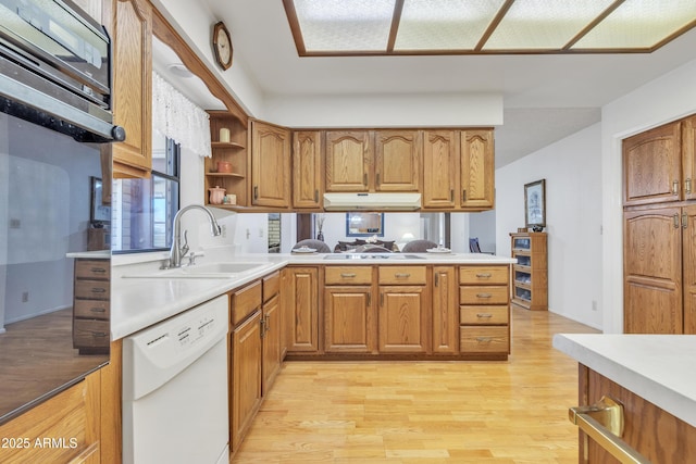 kitchen with brown cabinets, open shelves, light wood-style floors, white dishwasher, and a sink