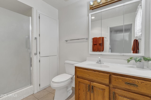 full bath featuring toilet, a stall shower, vanity, and tile patterned floors