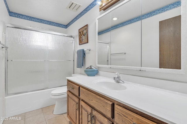 full bath with visible vents, toilet, enclosed tub / shower combo, vanity, and tile patterned flooring