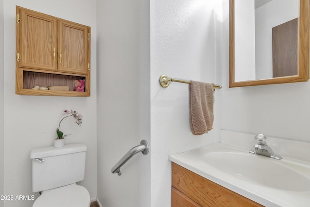 half bathroom with toilet and vanity