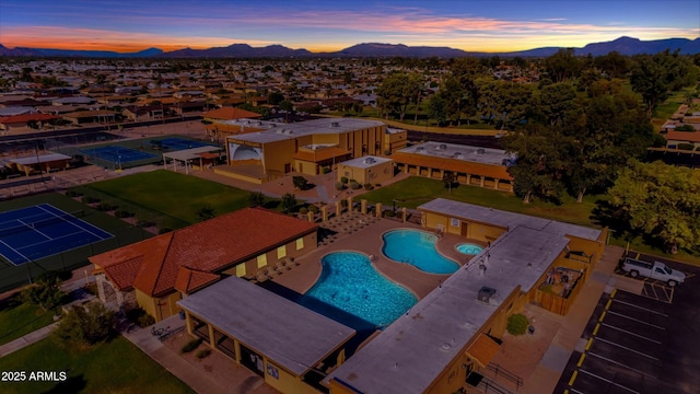 aerial view at dusk featuring a mountain view