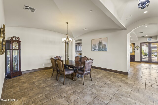 10125 E Cortez Dr, Scottsdale, AZ 85260 - dining space with stone tile floors, a chandelier, lofted ceiling, arched walkways, and recessed lighting