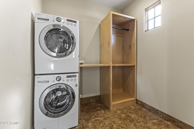 10125 E Cortez Dr, Scottsdale, AZ 85260 - laundry area featuring estacked washer and dryer and stone finish flooring