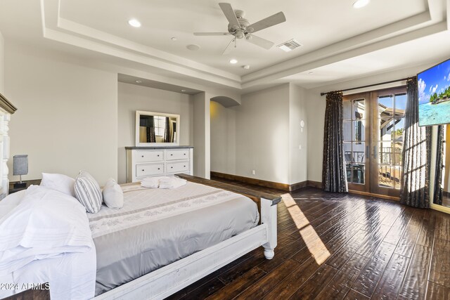10125 E Cortez Dr, Scottsdale, AZ 85260 - bedroom featuring a tray ceiling, access to outside, wood-type flooring, arched walkways, and recessed lighting