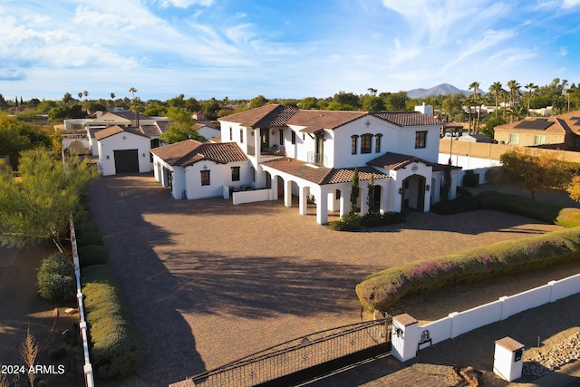 10125 E Cortez Dr, Scottsdale, AZ 85260 - mediterranean / spanish house with a residential view, a tiled roof, a garage, decorative driveway, and stucco siding