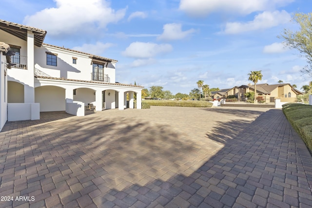 10125 E Cortez Dr, Scottsdale, AZ 85260 - view of side of home with a balcony, stucco siding, and a tiled roof