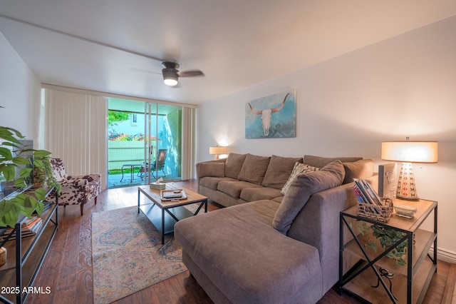 living room with dark hardwood / wood-style floors, a wall of windows, and ceiling fan