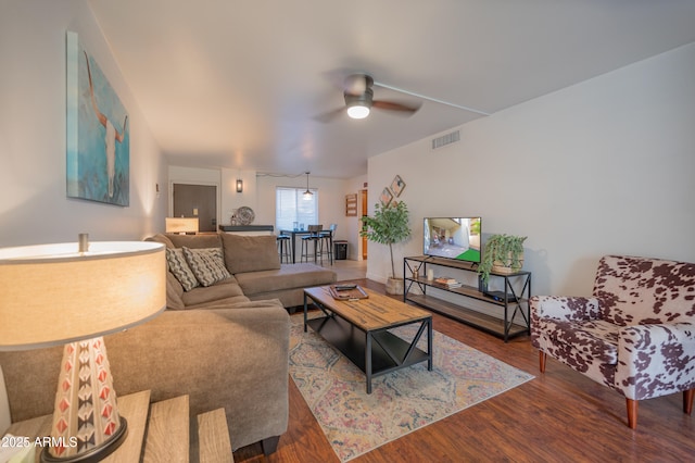 living room featuring ceiling fan and hardwood / wood-style flooring