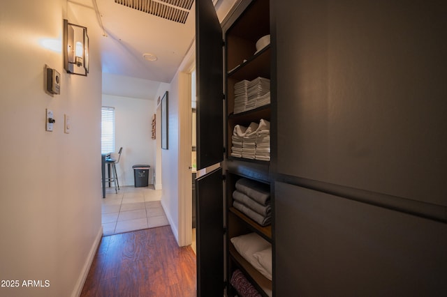 hallway with hardwood / wood-style floors